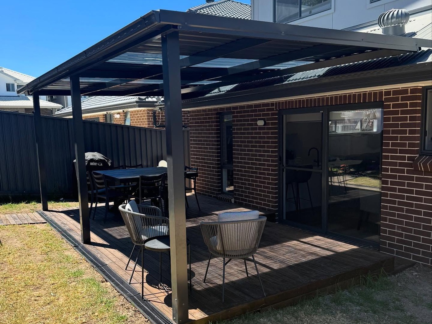 Timber pergola with slatted roof over an alfresco area